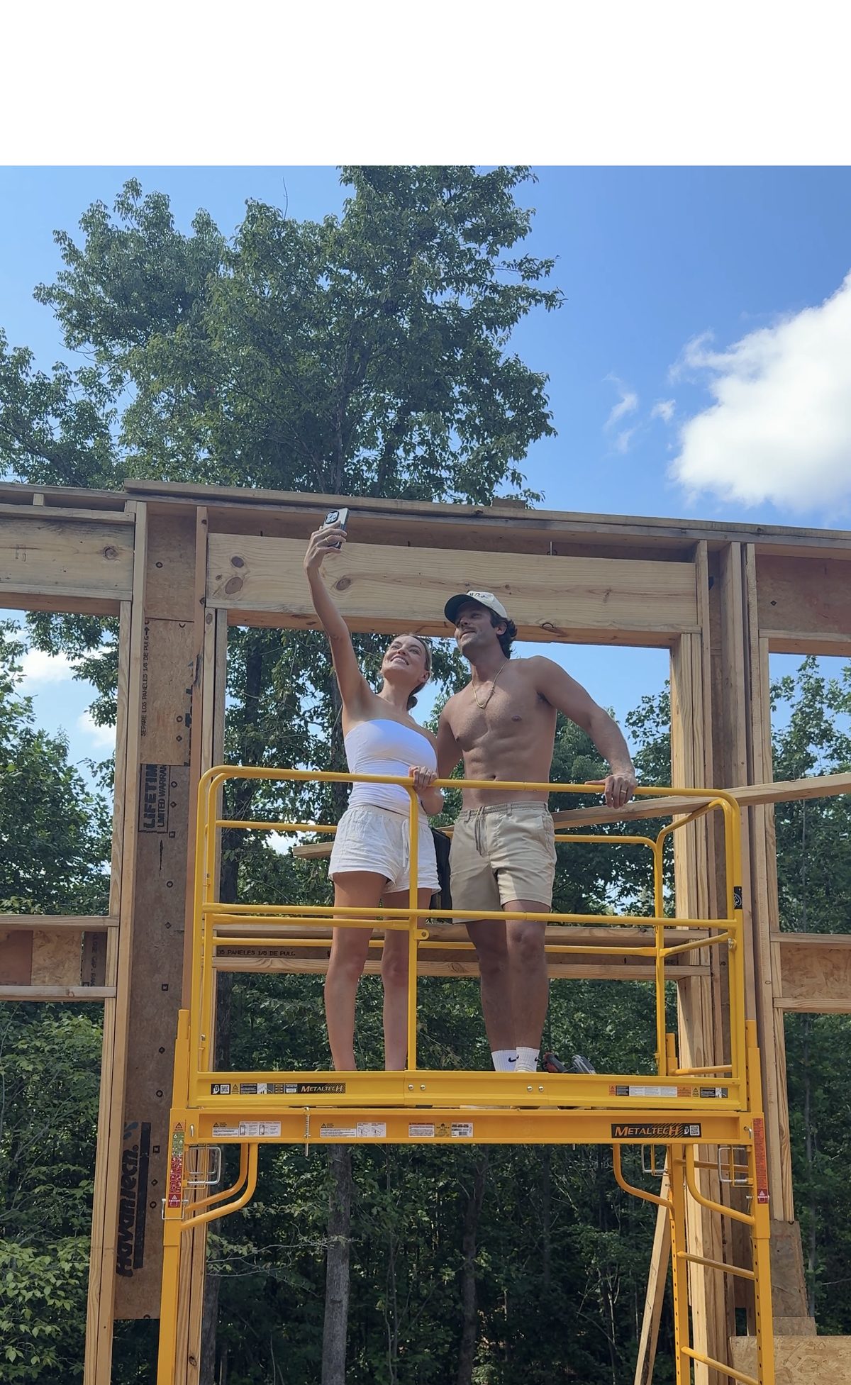Standing on scaffolding inside the framed walls